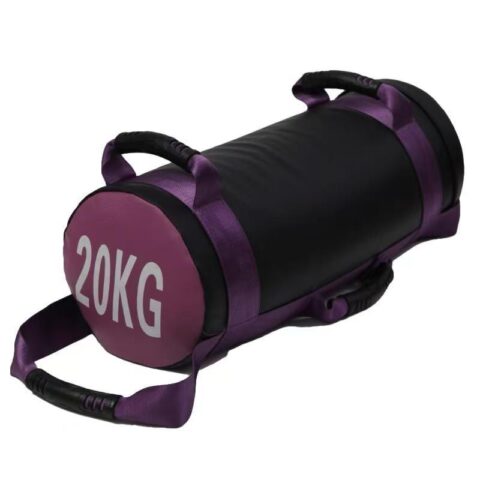 A cylindrical NF_10100_20 Energy Bag with reinforced handles on each side, designed for functional strength training. The bag features a durable, heavy-duty exterior with clear weight markings, and is ideal for exercises like squats, lunges, and presses in a gym or fitness studio setting