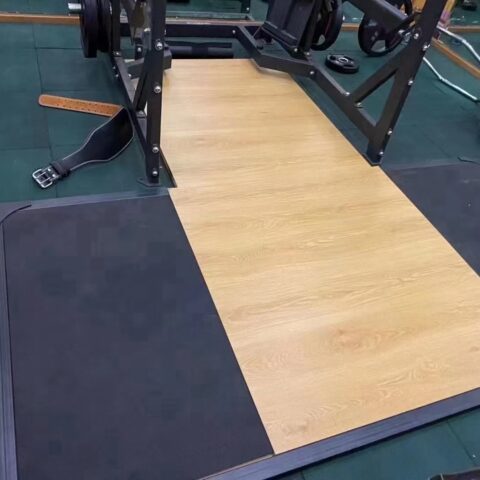 A robust squat training platform with a sturdy frame and a large, flat surface designed for heavy lifting. The platform features a non-slip, textured area for foot placement and an integrated lifting area to protect the floor during intense squats and other powerlifting exercises